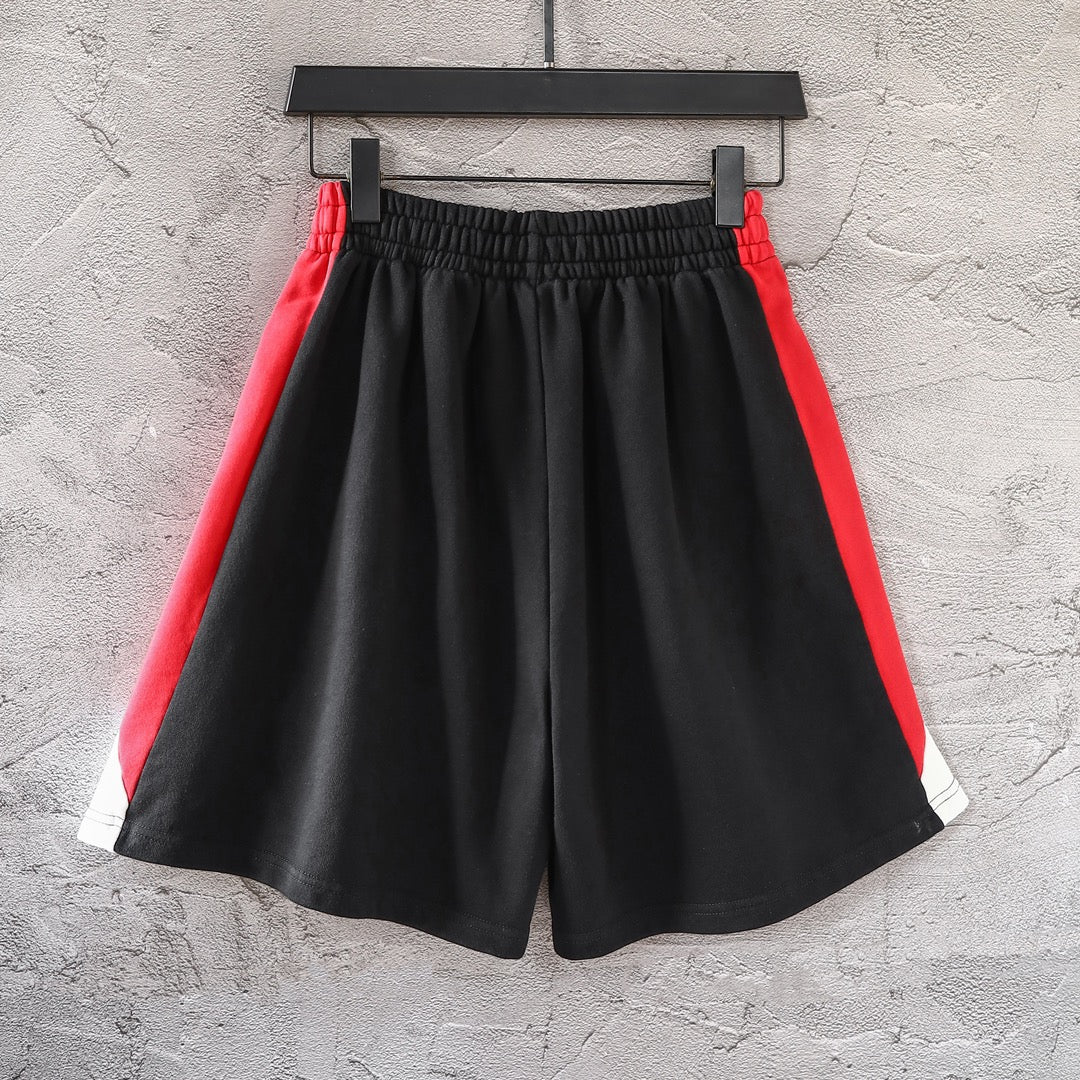 Black pants with red side panels, white trim, and elastic waistband