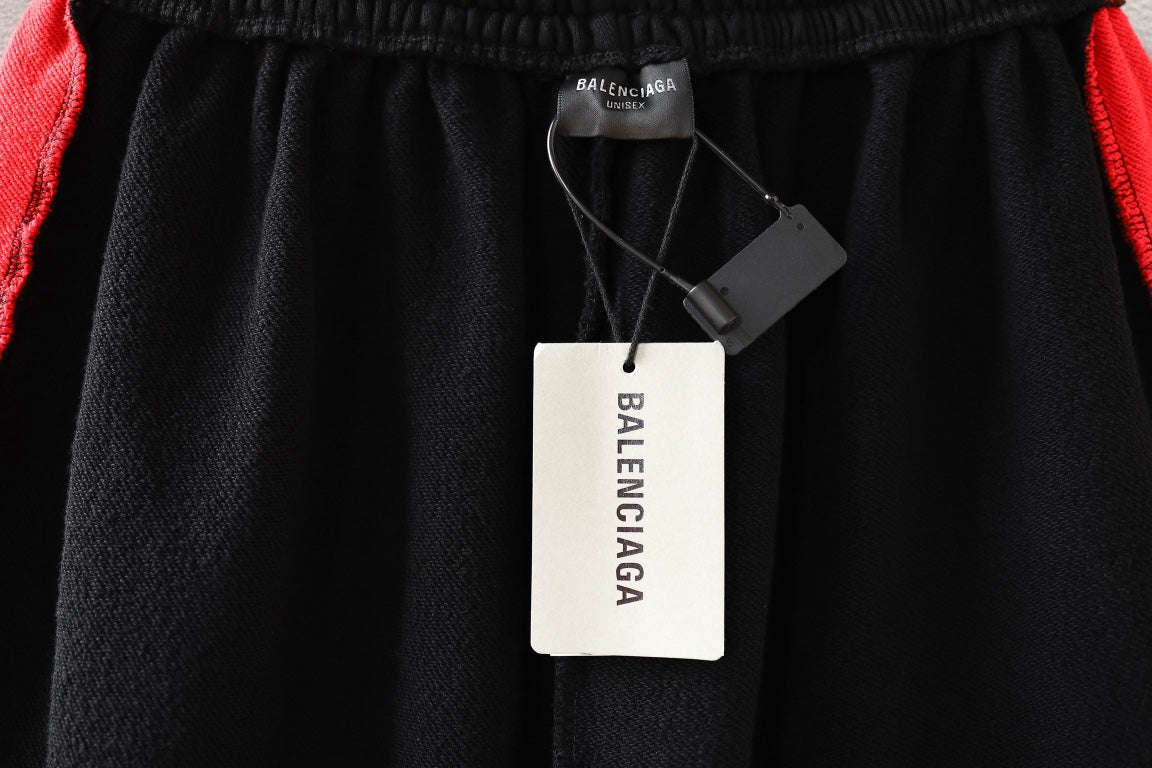 Black pants with elastic waistband and brand tags attached to the hanger