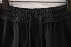Black pants with elastic waistband and gathered front pleats