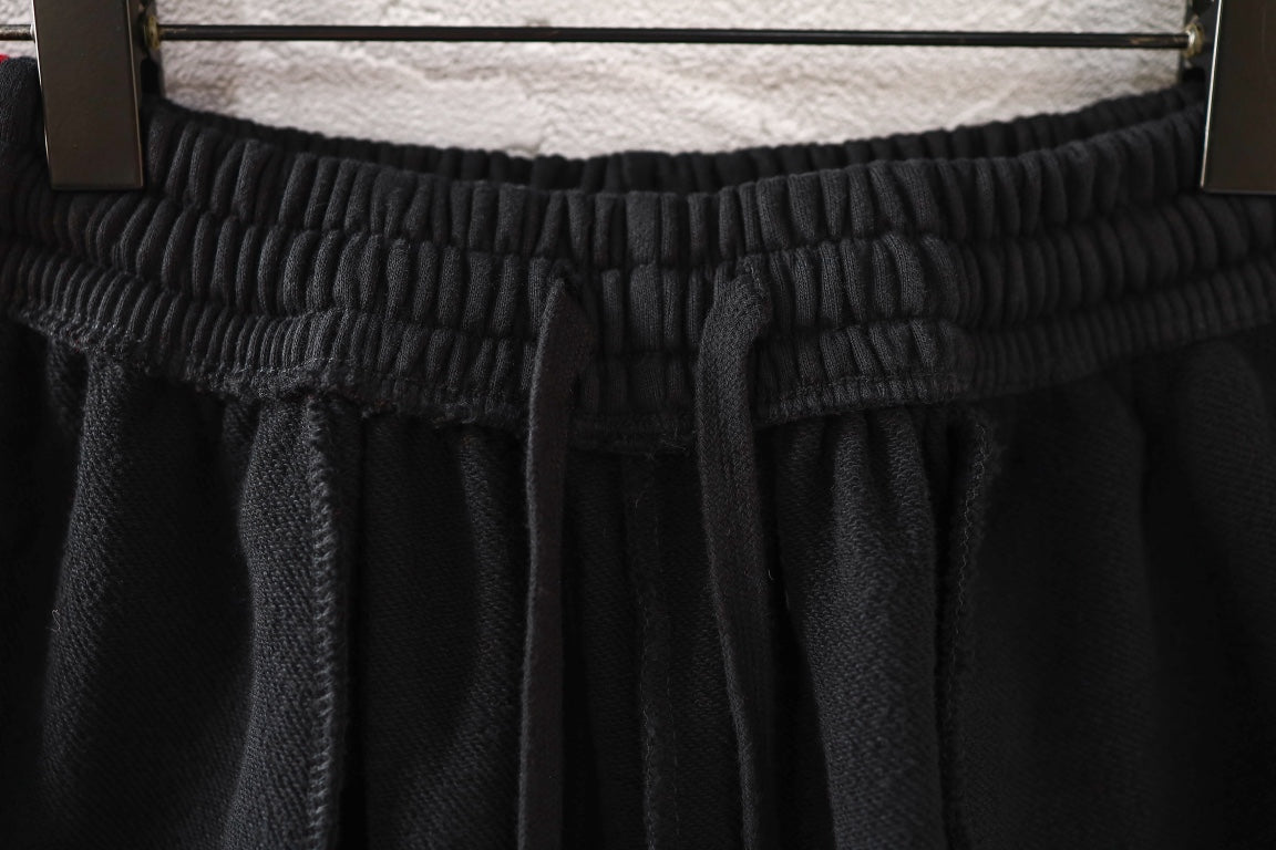 Black pants with elastic waistband and gathered front pleats