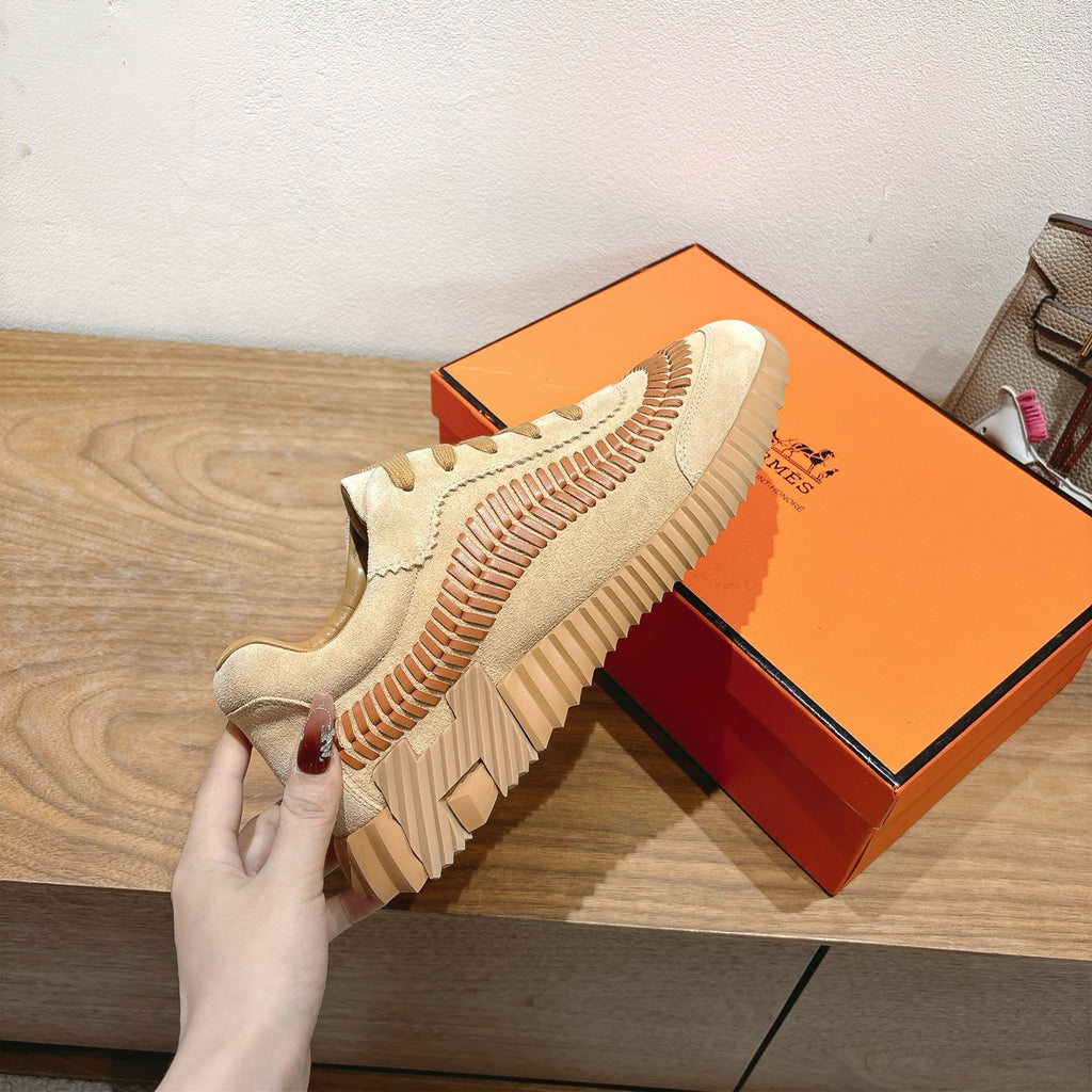 Unisex suede sneaker with orange stitched side stripe, tan laces, and thick sole