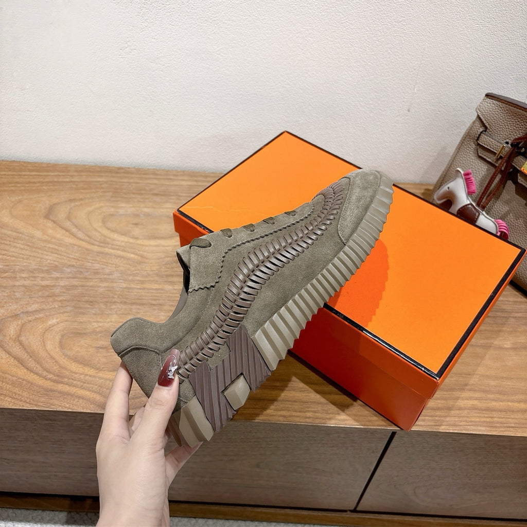 Olive suede lace-up sneaker with ridged side panels and tread sole