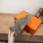 Olive suede lace-up sneaker with ridged side panels and tread sole
