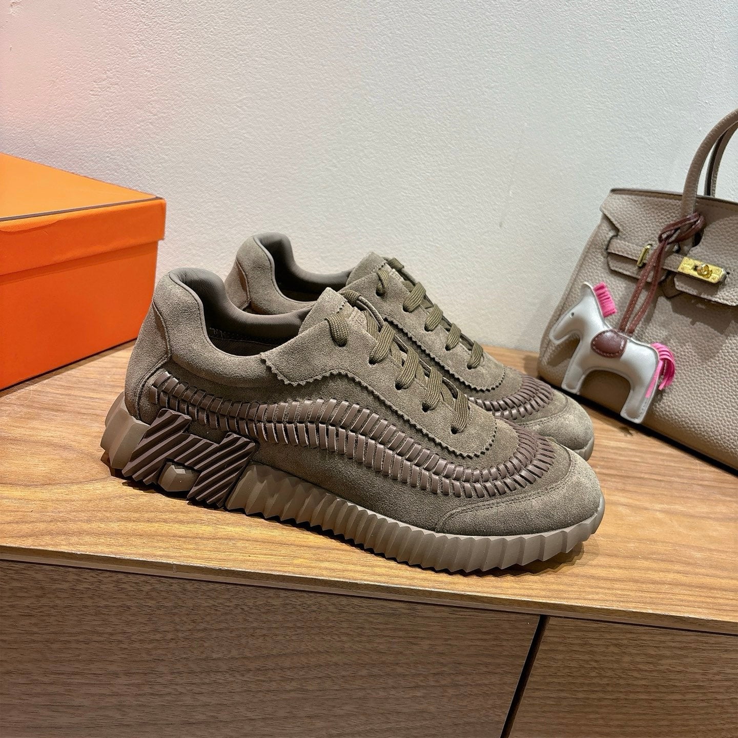 Olive suede lace-up sneakers shown in profile with ridged sole