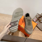 Olive suede sneaker with visible tread sole and lace-up upper