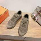 Pair of olive suede lace-up sneakers with chunky rubber sole