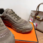 Close-up of olive suede lace-up sneakers with patterned rubber side sole