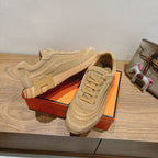 Beige Hermes unisex sneakers showing outsole tread and lace-up front