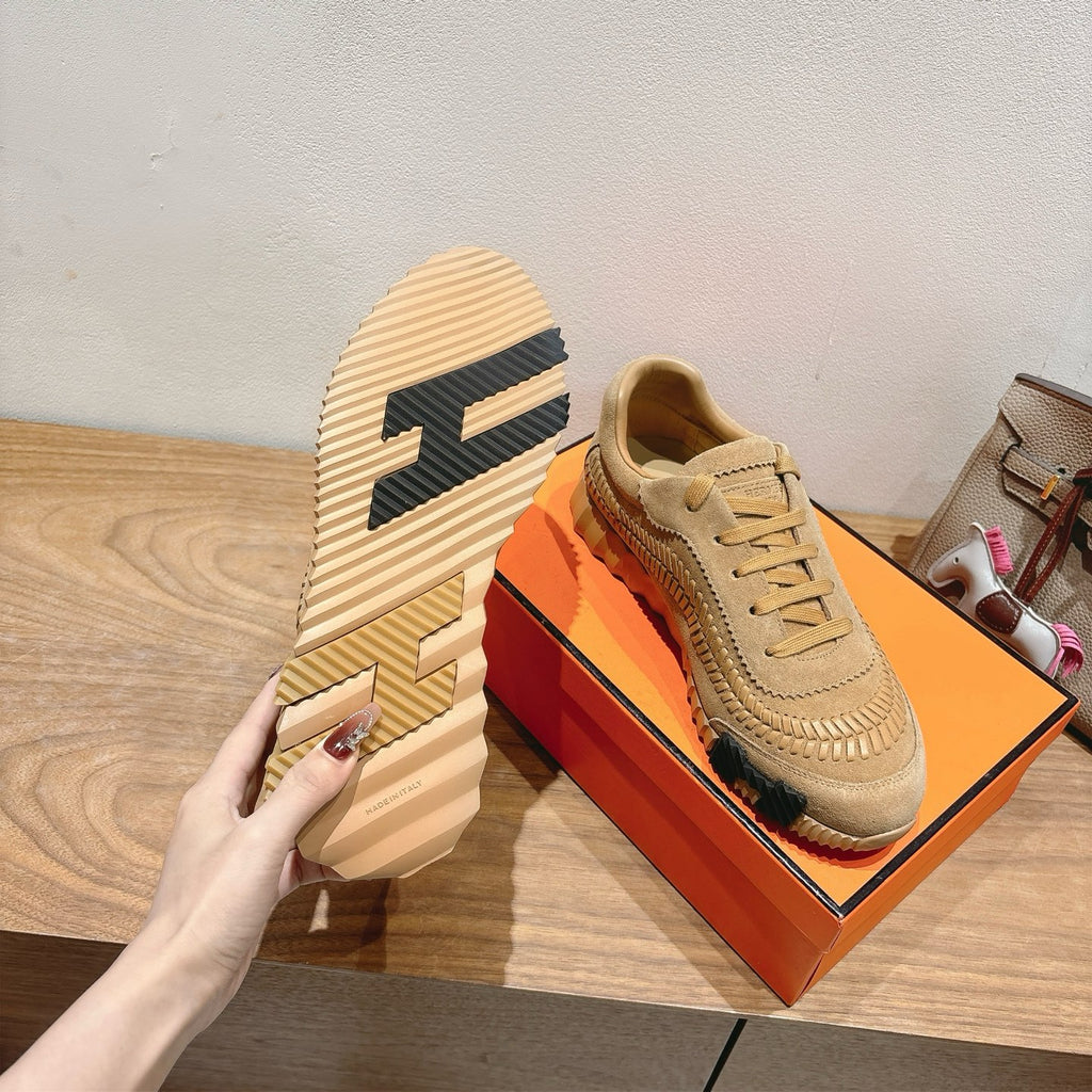 Beige Hermes unisex sneakers with bold patterned heel and lace-up design
