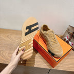 Beige Hermes unisex sneakers with bold patterned heel and lace-up design