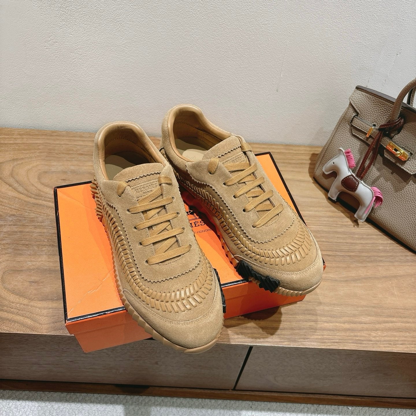 Beige Hermes unisex sneakers with lace-up and decorative stitched toe guard
