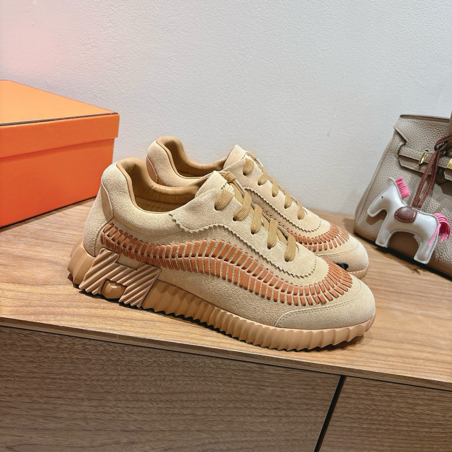Unisex suede sneakers in beige with tan laces and orange stitched arc trim