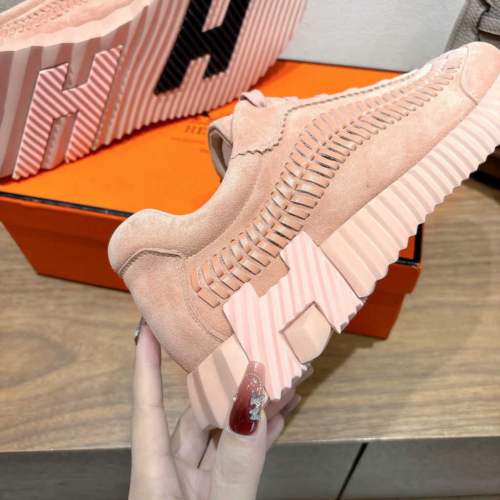 Hermes light pink lace-up sneaker close-up with textured outsole and stacked midsole