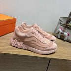 Hermes light pink lace-up sneakers with ribbed sole and stitched upper design