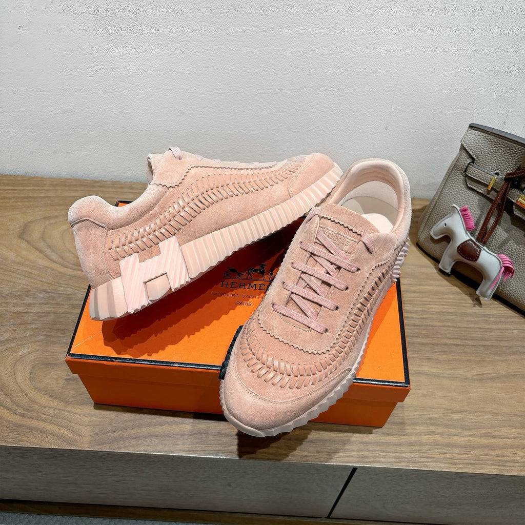 Hermes light pink lace-up sneakers on orange box, suede upper with ridged sole