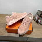 Hermes light pink lace-up sneakers on orange box, suede upper with ridged sole