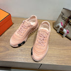 Pair of Hermes light pink lace-up sneakers with suede texture and cushioned sole detail