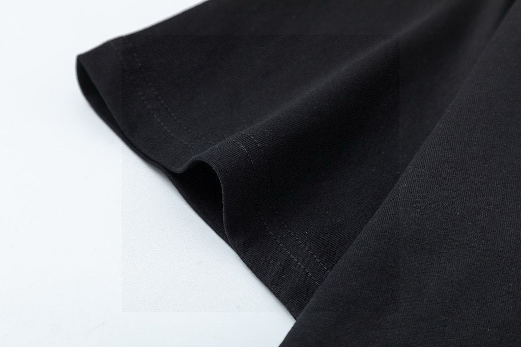 Black T-shirt fabric and hem seam close-up