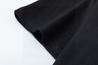 Black T-shirt fabric and hem seam close-up