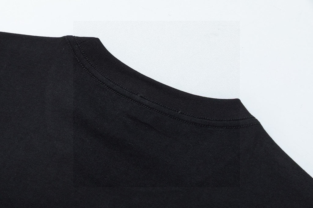 Black crewneck collar seam and ribbed neckline close-up