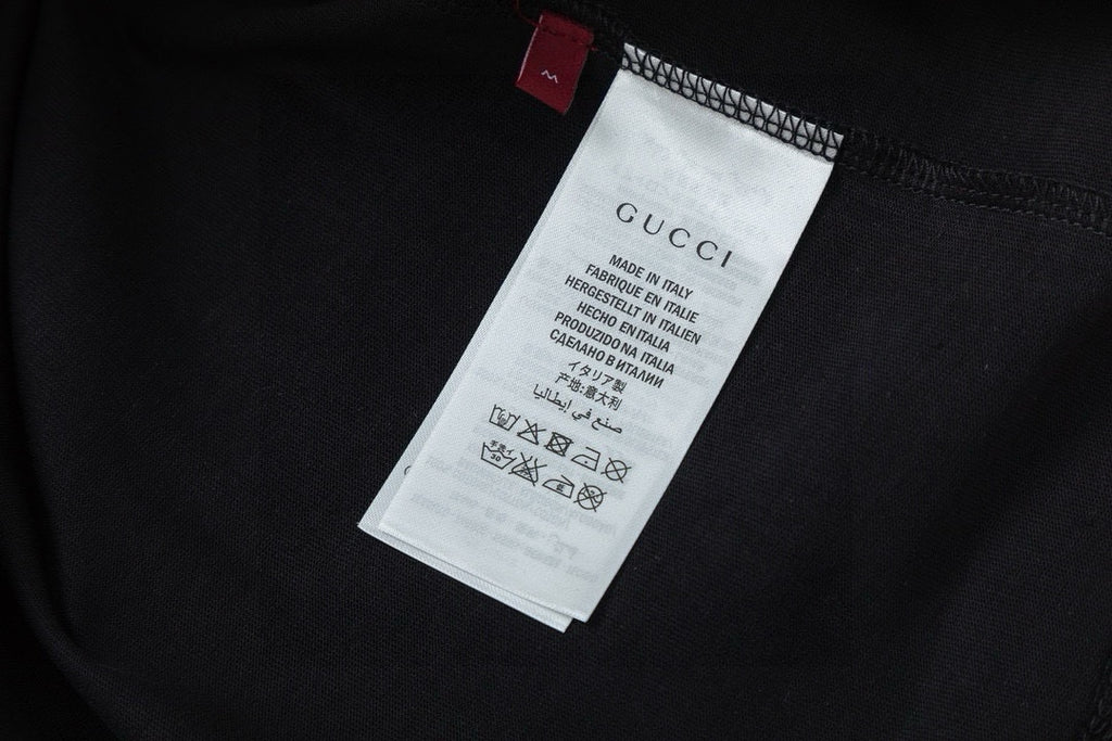 Inside neck label and care tag on Gucci black T-shirt