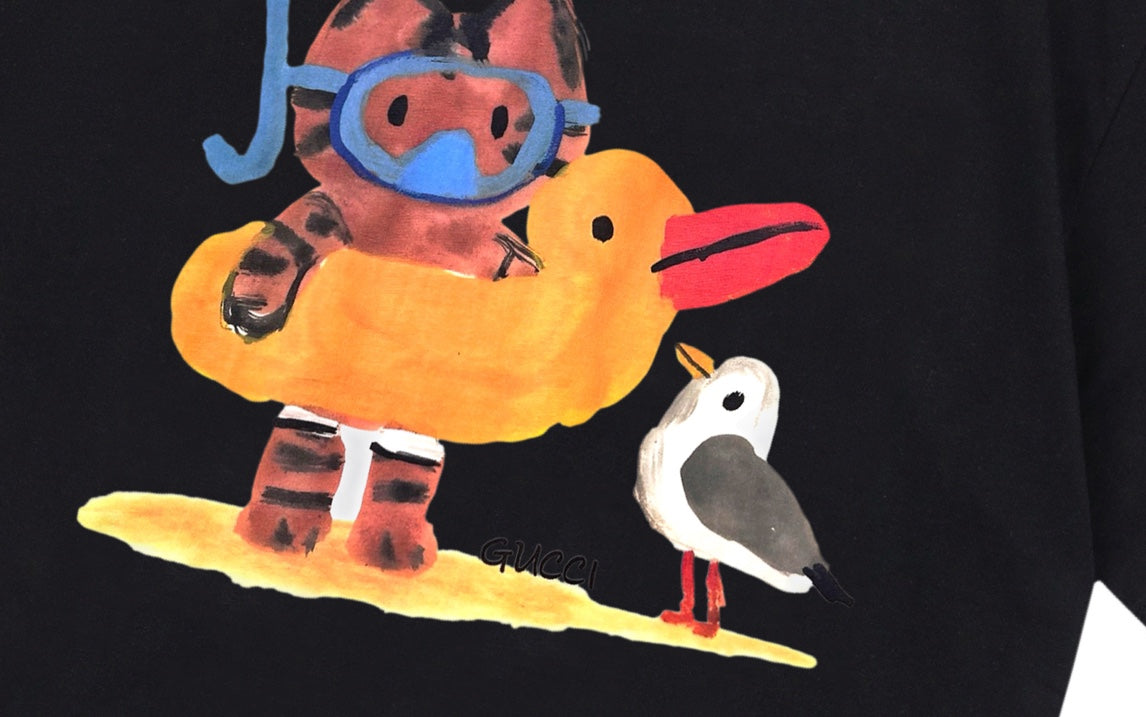 Colorful character graphic on black short-sleeve T-shirt with cartoon bird