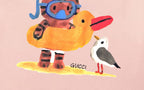 Pink short-sleeve T-shirt with colorful cartoon animal graphic and small Gucci text