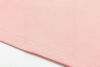 Pink short-sleeve T-shirt hem with visible stitched edge