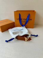 Louis Vuitton belt with brown leather strap and LV silver-tone buckle, in cloth pouch.