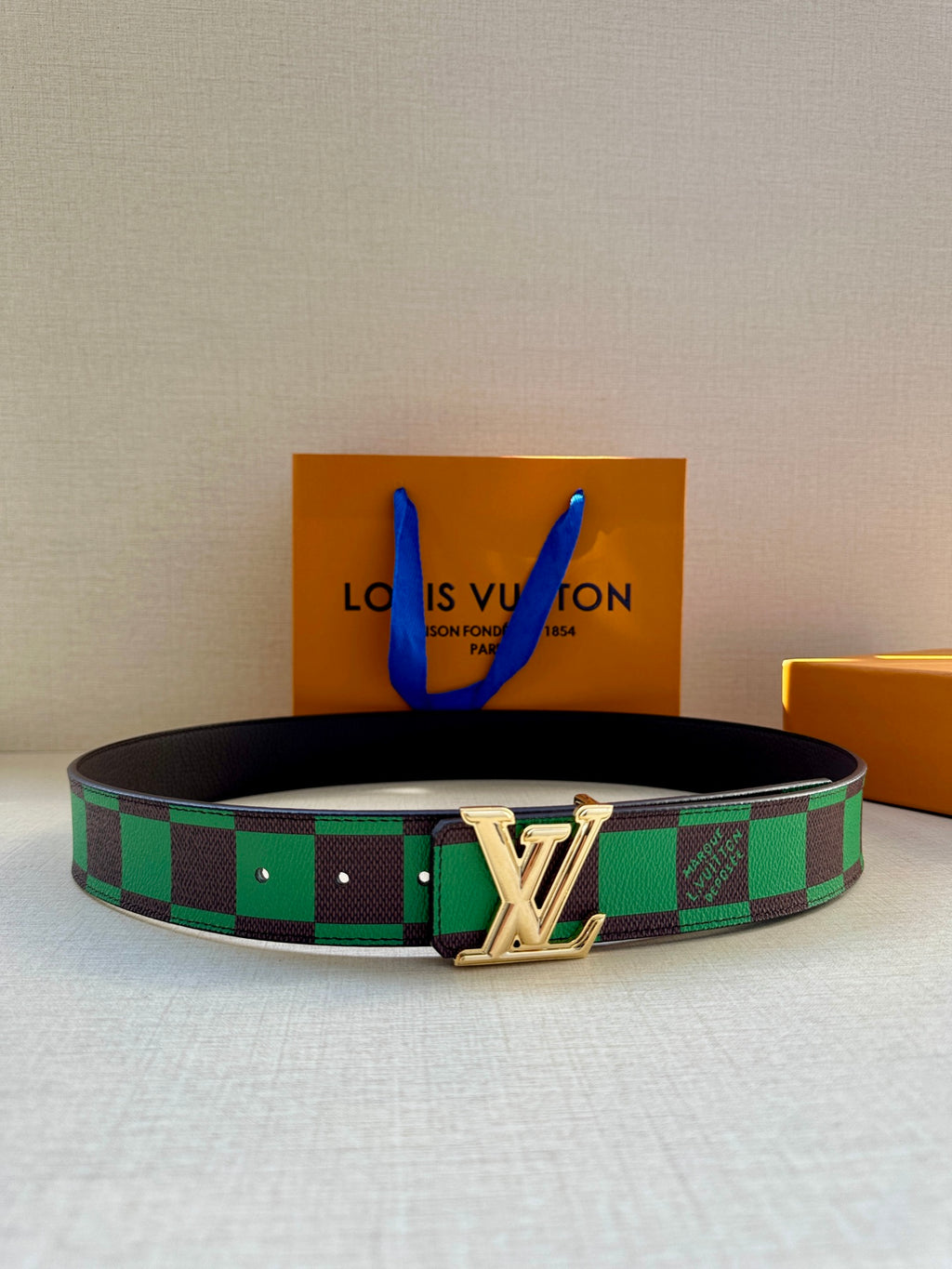 Louis Vuitton belt with green check canvas pattern and silver LV buckle