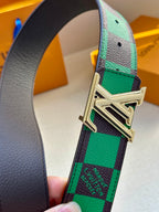 Louis Vuitton belt buckle close-up on green-and-black check strap