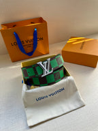 Louis Vuitton belt with green check strap and silver LV buckle on white pouch