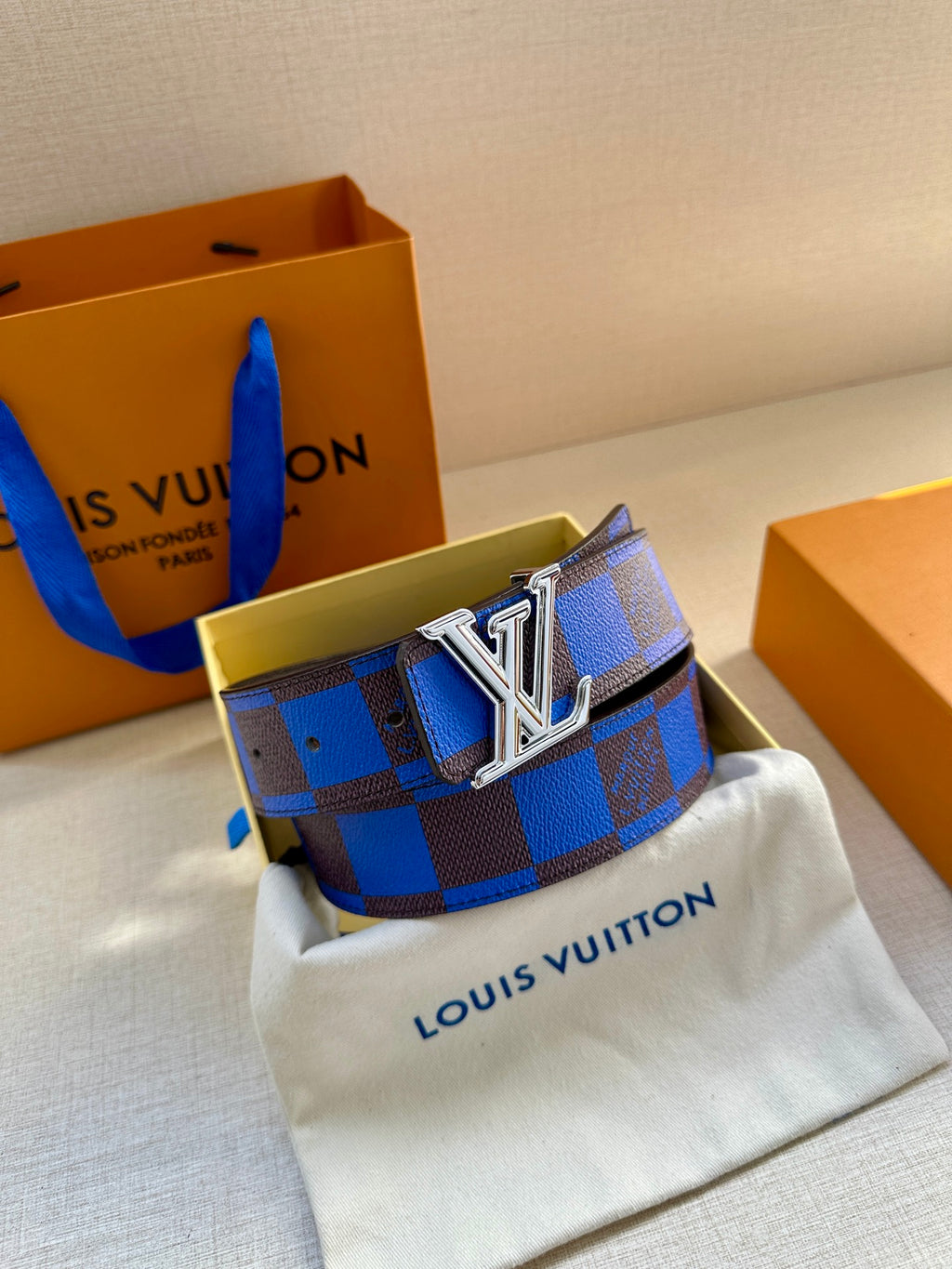 Louis Vuitton belt with blue and black check pattern and silver LV buckle