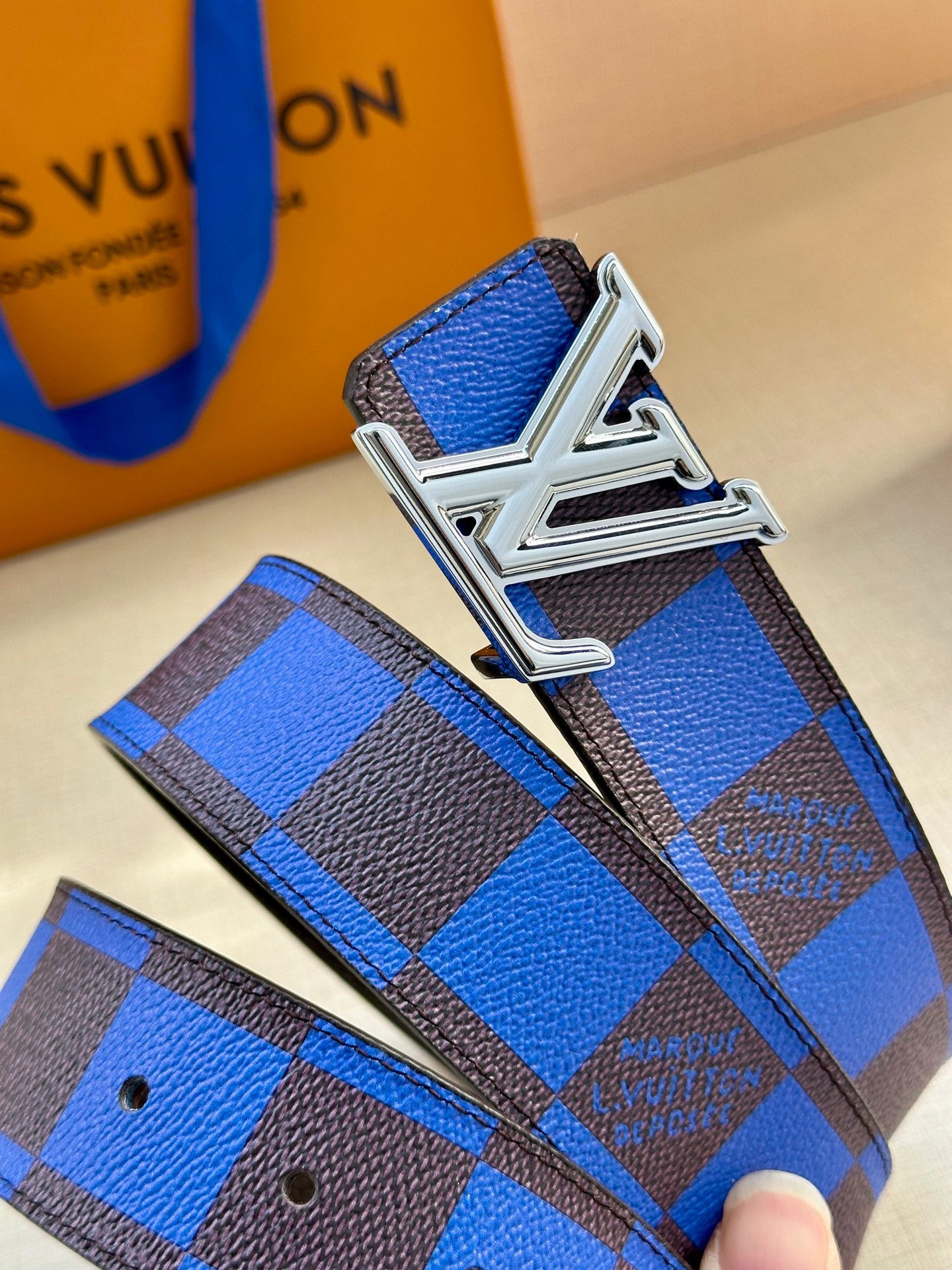 Louis Vuitton belt with blue and black checked strap and silver buckle