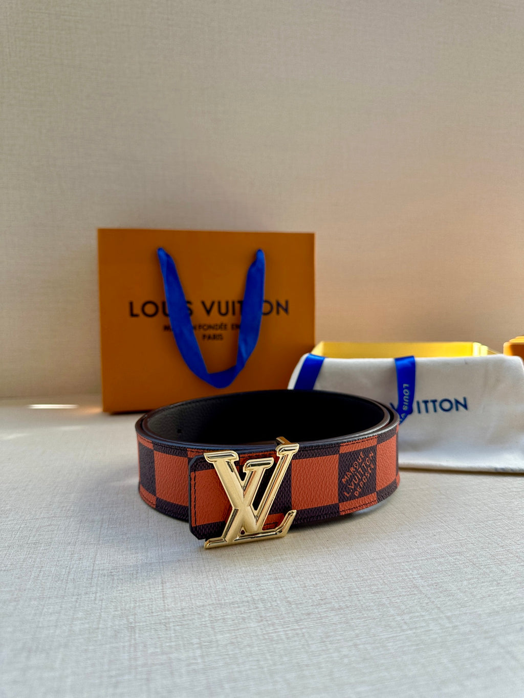 Checker-print belt with silver LV buckle and black leather backing