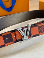 Close-up of orange and navy checker belt with silver buckle