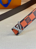 Orange and navy checker belt with silver buckle on dark leather strap