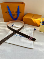 Louis Vuitton monogram belt with pink LV buckle and tan leather strap