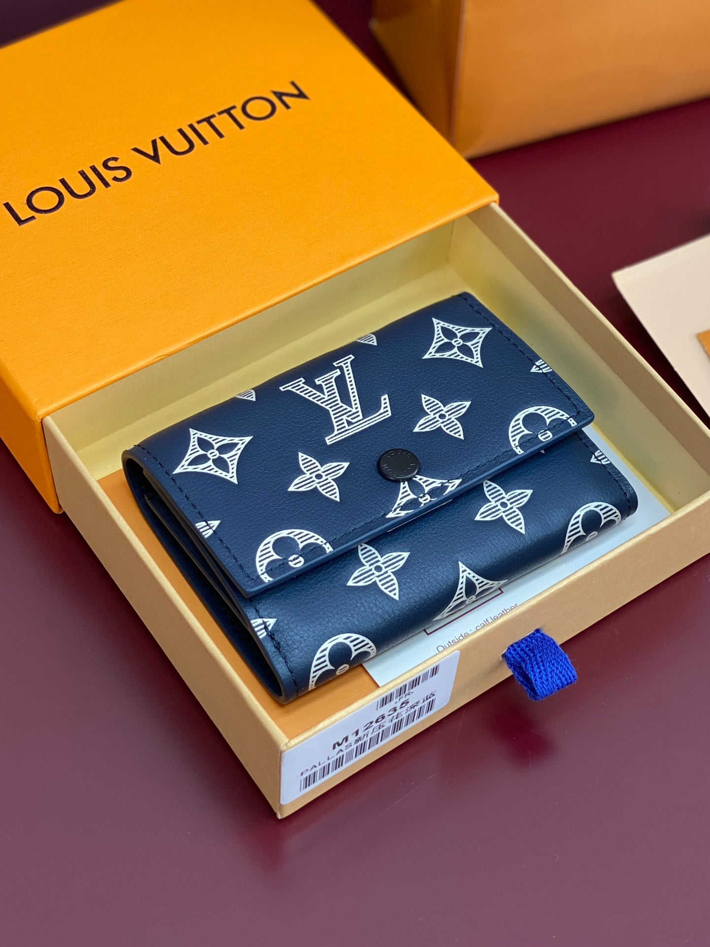 Blue small wallet with Louis Vuitton monogram pattern, partially open