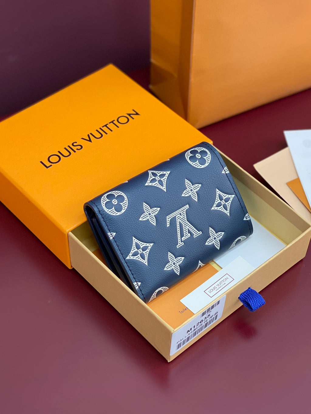 Blue small wallet with Louis Vuitton monogram and butterfly motifs, flap closure