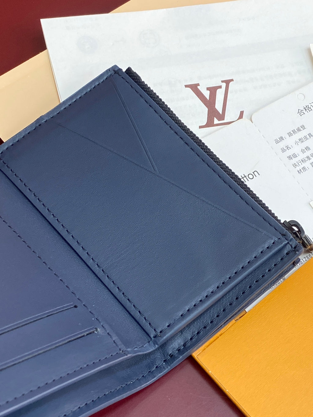 Blue leather card holder with stitched panels, card slot divider, zipper edge