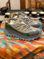 Light gray sneakers with olive band, purple midsole, turquoise treaded outsole