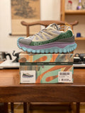 Light gray sneakers with olive accents, purple midsole, turquoise treaded sole