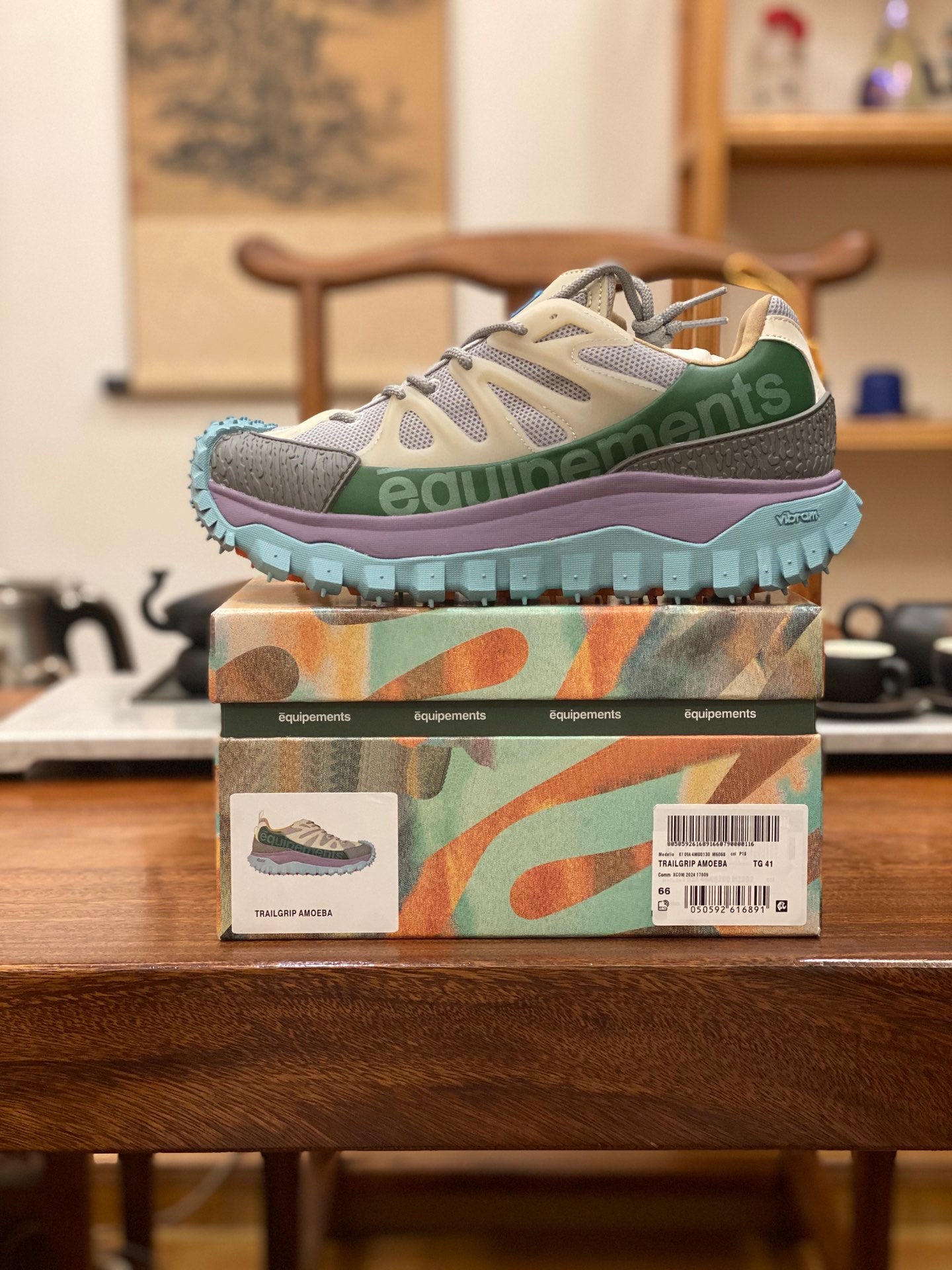 Light gray sneakers with olive accents, purple midsole, turquoise treaded sole