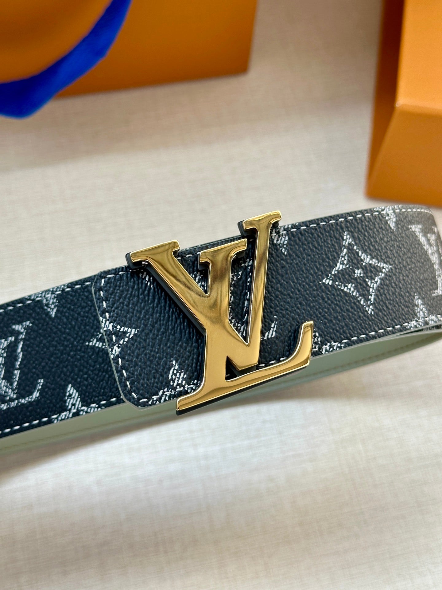 Louis Vuitton belt with navy monogram canvas and gold-tone LV buckle