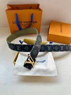 Louis Vuitton belt with navy monogram canvas, silver LV buckle, and green strap
