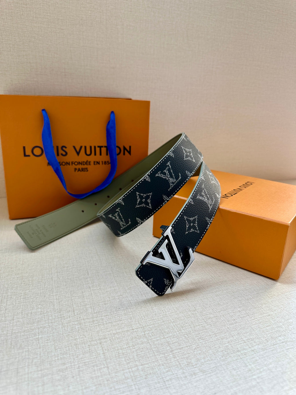 Louis Vuitton belt with navy monogram strap and silver-tone LV buckle