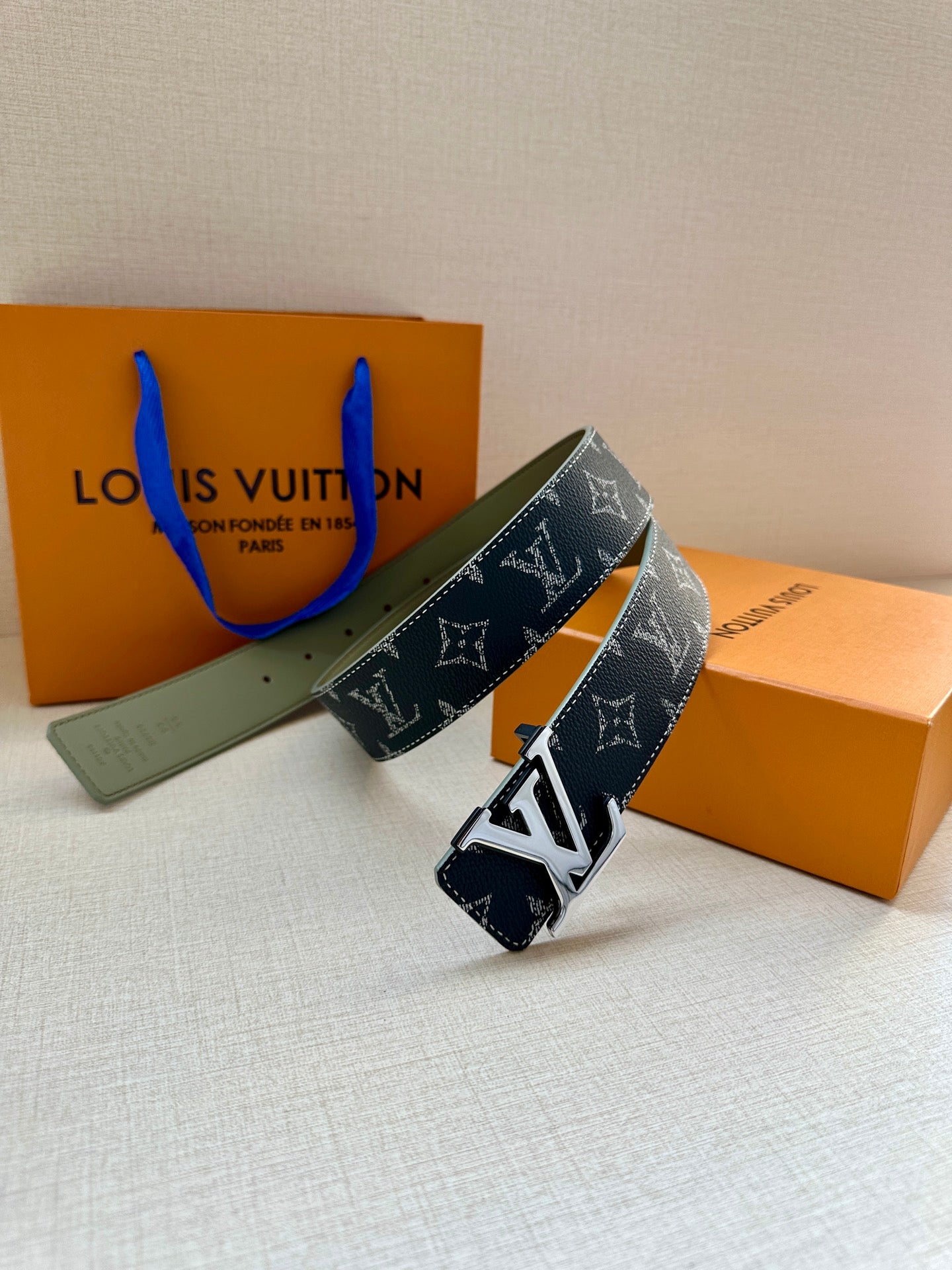 Louis Vuitton belt with navy monogram strap and silver-tone LV buckle