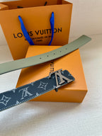 Louis Vuitton belt with navy monogram strap, silver LV buckle, and light-green edge