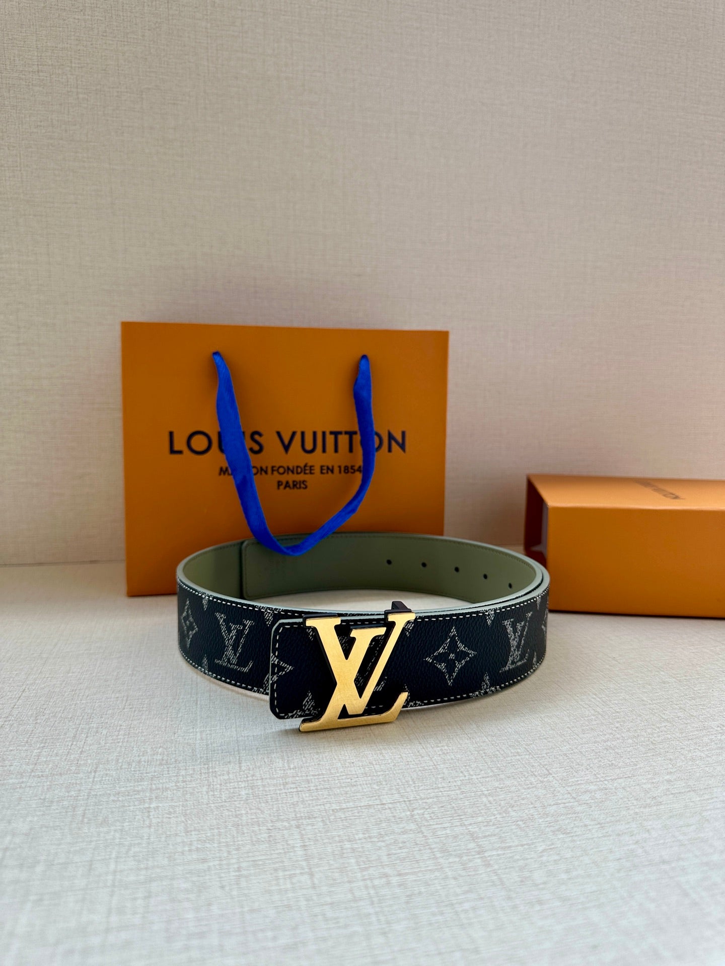 Louis Vuitton belt with navy monogram canvas and gold-tone LV buckle